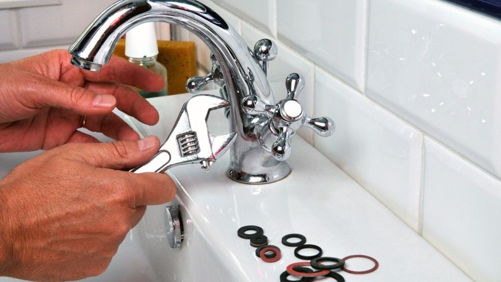 plumber-repairing-a-bathroom-faucet